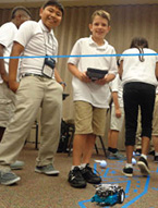 Students work with an mBot robot during NYLF Pathways to STEM