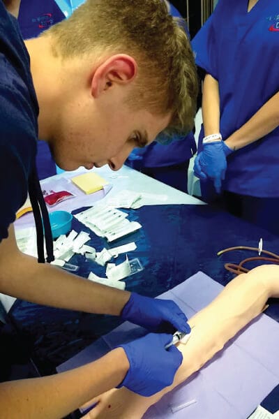 High School Student getting Emergency Medical Training