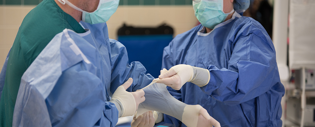 Medical professionals putting on PPE