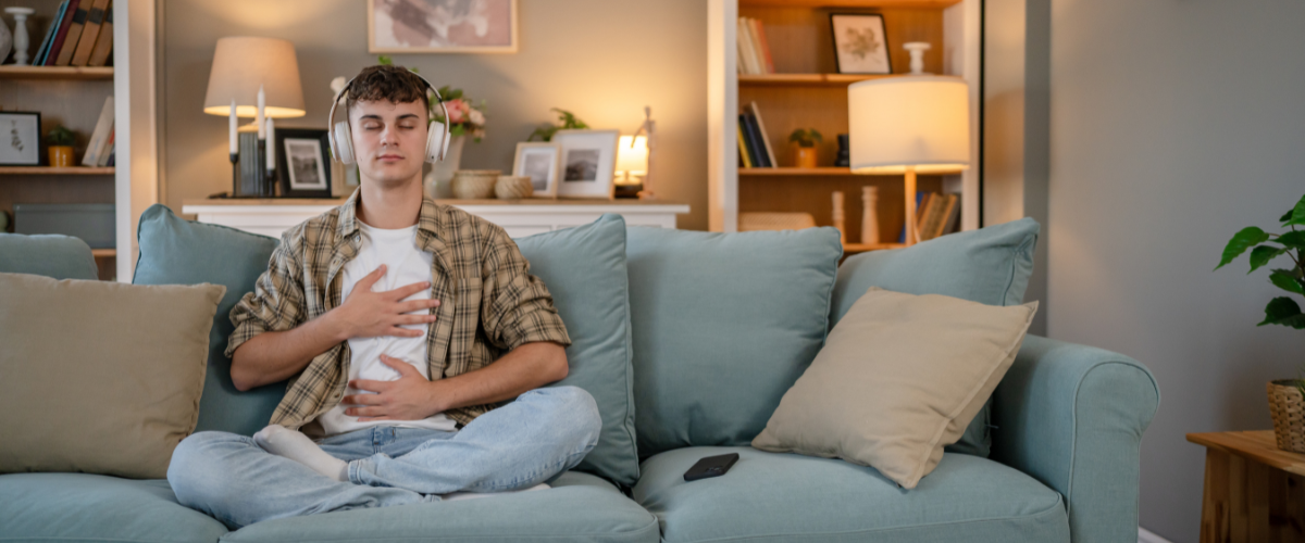 Student sitting on a couch practicing meditation