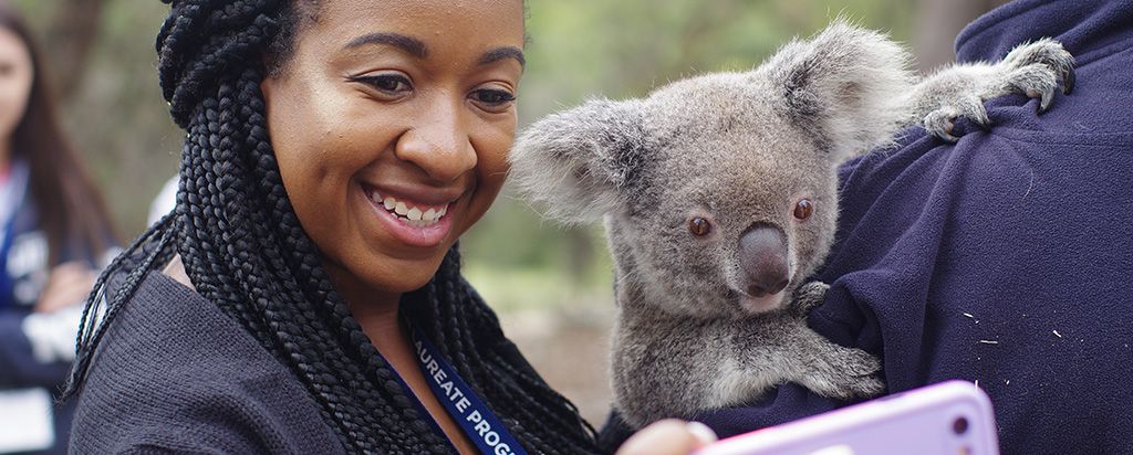 ISLP student studying abroad in Australia takes a selfie with a Koala
