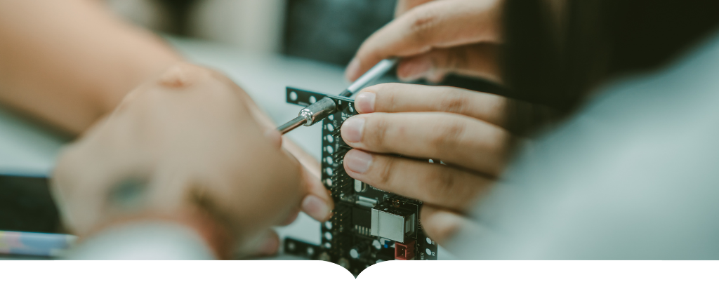 Hands working on a circuit board