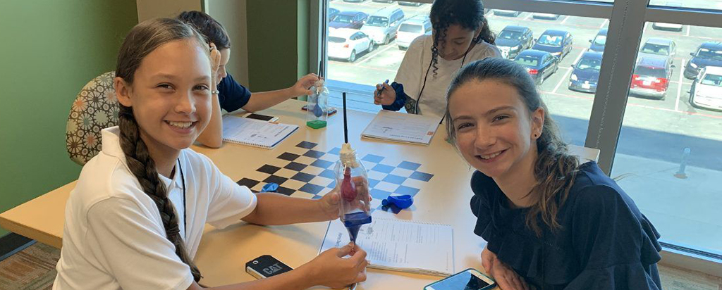 Students working on STEM projects with Envision Experience