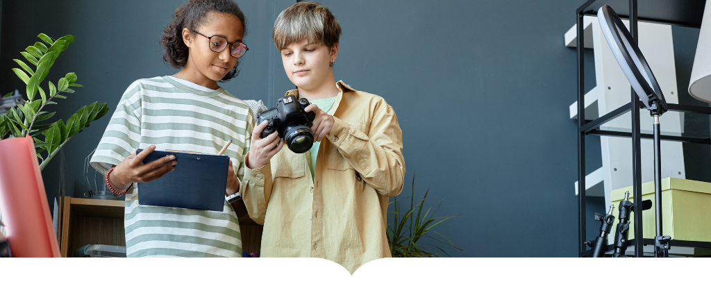 Two students looking at a camera