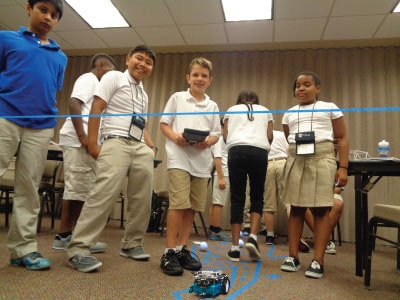 Students test their mBot robot in the Engineering pathway at NYLF Pathways to STEM